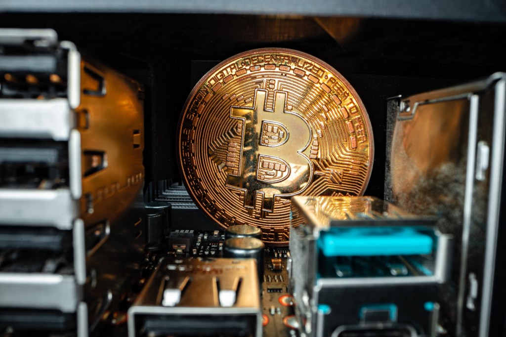Macro photo of bitcoin cryptocurrency in the dark close up inside the mining rack featuring mining rewards and blockchain technology.